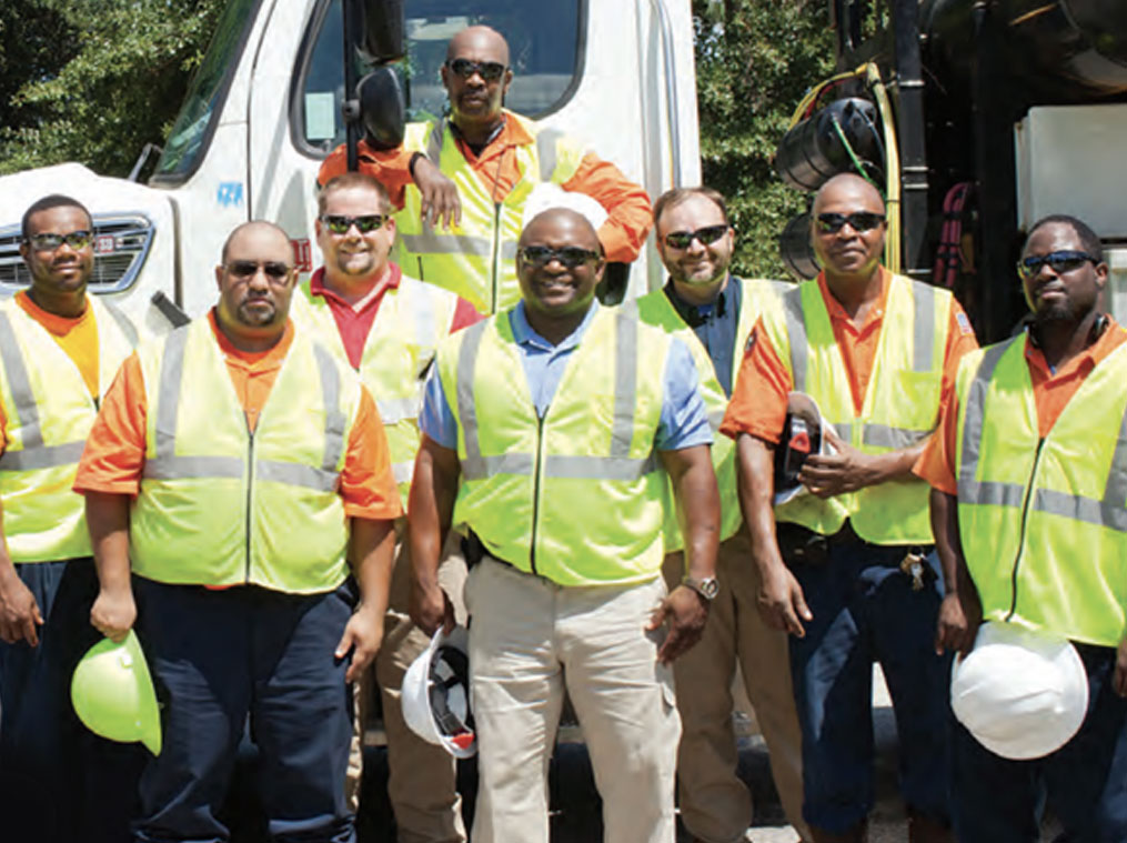 Group of Augusta municipal sewer and wastewater workers smiling.