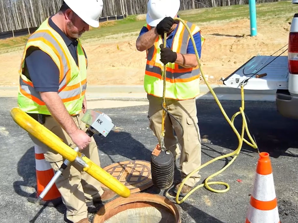 Two municipal sewer workers using SL-RAT to test for pipe blockage in Gwinnett County streets