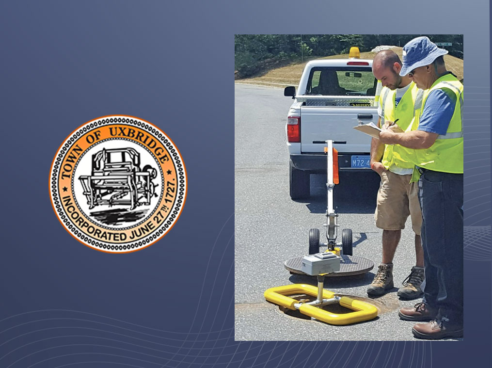 Two municipal workers looking at SL-RAT sewer blockage data