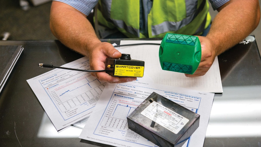 Person sitting at table reading sewer blockage inspection data.