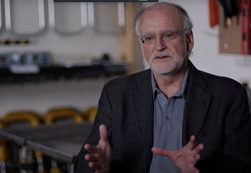 Dr. Ivan Howitt in InfoSense headquarters, speaking to camera.